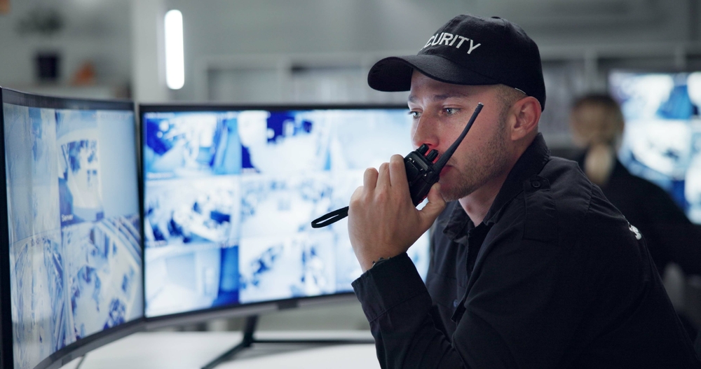 Man,,Security,Guard,On,Radio,And,Speaking,By,Cctv,Monitor